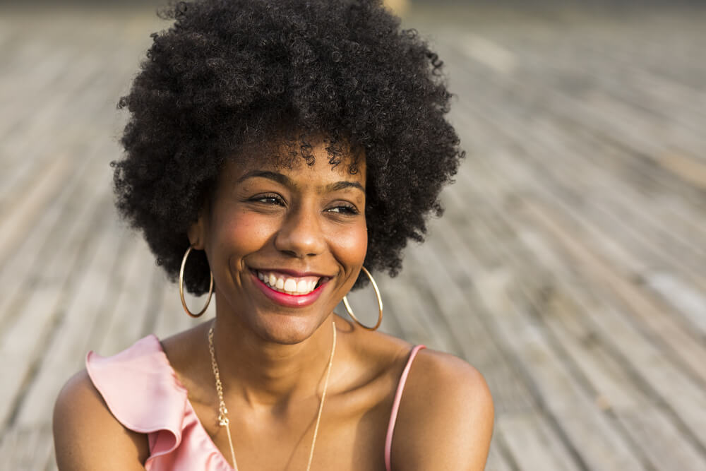 Smiling woman with afro out in the sun